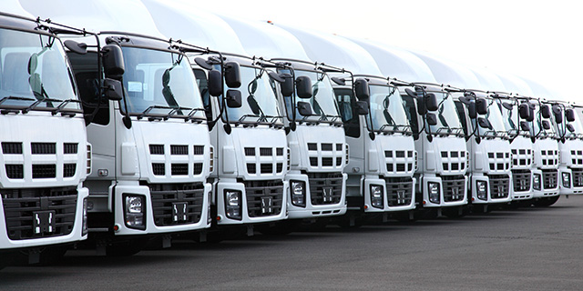 trucks (AmE) or lorries (BrE)