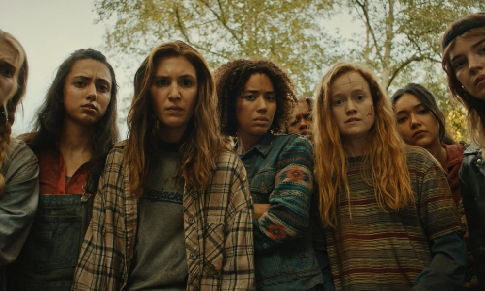 Yellowjackets Season 3 cast members in intense forest scene from Showtime's hit psychological thriller