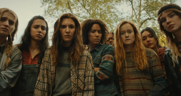Yellowjackets Season 3 cast members in intense forest scene from Showtime's hit psychological thriller